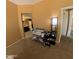 Neutral-toned bedroom with carpet, next to the bathroom with a large framed mirror and double vanity at 23771 W Yavapai St, Buckeye, AZ 85326
