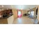 Open floor plan living room with tile flooring and ample natural light at 23771 W Yavapai St, Buckeye, AZ 85326