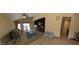 Spacious living room featuring tile flooring, a ceiling fan, and a built-in media center at 23771 W Yavapai St, Buckeye, AZ 85326