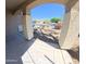 Covered front porch with stone columns and view of the neighborhood at 23771 W Yavapai St, Buckeye, AZ 85326