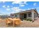 Backyard featuring a wood table with chairs and covered patio at 2410 S 124Th Dr, Avondale, AZ 85323