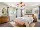 Bright bedroom features a ceiling fan, neutral décor, and multiple windows at 2410 S 124Th Dr, Avondale, AZ 85323