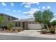 Charming single-story home featuring a tile roof, desert landscaping, and a two-car garage at 2410 S 124Th Dr, Avondale, AZ 85323