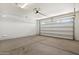 Spacious garage with concrete flooring and an automatic overhead door at 2410 S 124Th Dr, Avondale, AZ 85323
