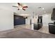 Open living space with kitchen island, ceiling fan and neutral color palette at 2410 S 124Th Dr, Avondale, AZ 85323