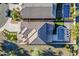 This overhead view shows the tile roof, pool, putting green, lush landscaping, and backyard oasis of the property at 25155 N 108Th Ave, Peoria, AZ 85383