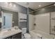 Well-lit bathroom featuring a shower-tub combo and a vanity with a framed mirror at 25155 N 108Th Ave, Peoria, AZ 85383