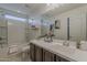 Bright bathroom featuring a tub with shower and a sleek vanity with generous counter space at 25155 N 108Th Ave, Peoria, AZ 85383