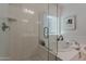 All-white bathroom with separate tub, modern shower and bright natural light at 25155 N 108Th Ave, Peoria, AZ 85383