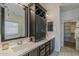 Bathroom with modern, dark wood vanity and lots of storage space at 25155 N 108Th Ave, Peoria, AZ 85383