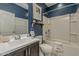 Bathroom with blue walls, white fixtures, and a framed mirror above the sink at 25155 N 108Th Ave, Peoria, AZ 85383
