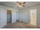 Carpeted bedroom with ceiling fan, closet and doorways providing easy access to other rooms at 25155 N 108Th Ave, Peoria, AZ 85383