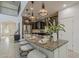 Kitchen island with granite countertops and seating, pendant lighting, stainless steel appliances at 25155 N 108Th Ave, Peoria, AZ 85383