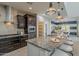 Kitchen island with granite countertops and seating, pendant lights, and stainless steel appliances at 25155 N 108Th Ave, Peoria, AZ 85383