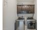 Laundry room featuring a side-by-side washer and dryer and storage cabinet at 25155 N 108Th Ave, Peoria, AZ 85383