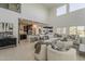 Enjoy the open layout of this living room, with its soaring ceilings, natural light, and seamless flow to the kitchen at 25155 N 108Th Ave, Peoria, AZ 85383