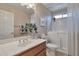 Bathroom featuring a stylish vanity, well-lit mirror, and a bathtub with shower and shower curtains at 2984 N 152Nd Dr, Goodyear, AZ 85395