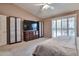 Spacious primary bedroom with neutral tones, carpet, custom closets, and plantation shutters at 2984 N 152Nd Dr, Goodyear, AZ 85395
