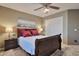 Cozy bedroom with a ceiling fan, carpet, a sliding closet, and a serene painting above the bed at 2984 N 152Nd Dr, Goodyear, AZ 85395