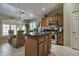 Kitchen showcasing the island, stainless steel oven, stove, microwave, and eat-in dining space with large windows at 2984 N 152Nd Dr, Goodyear, AZ 85395