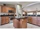 Spacious kitchen includes an island with granite countertops and stainless steel appliances at 2984 N 152Nd Dr, Goodyear, AZ 85395