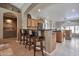 Open kitchen features a breakfast bar with seating, stainless steel appliances, and tile flooring at 2984 N 152Nd Dr, Goodyear, AZ 85395