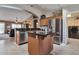 The kitchen has an island, sink, stainless steel appliances, and an entry to the laundry room at 2984 N 152Nd Dr, Goodyear, AZ 85395