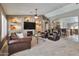 Spacious living room with built-in shelving, a cozy fireplace, plush seating, and an open floor plan at 2984 N 152Nd Dr, Goodyear, AZ 85395