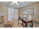 Bright office with neutral carpet, a ceiling fan, a sliding closet, and comfortable seating for guests at 2984 N 152Nd Dr, Goodyear, AZ 85395