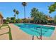 Lush backyard showcasing a private pool with mature landscaping and artificial turf at 2984 N 152Nd Dr, Goodyear, AZ 85395