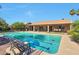 Inviting backyard with a large, private pool perfect for relaxation and entertaining under the covered patio at 2984 N 152Nd Dr, Goodyear, AZ 85395