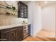 Stylish bar area with wine fridge and glass shelving at 3153 E Sierra Vista Dr, Phoenix, AZ 85016