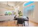 Contemporary dining area features modern furniture, a block glass window, and lots of natural light at 3153 E Sierra Vista Dr, Phoenix, AZ 85016