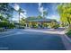 Elegant gated community entrance featuring lush landscaping, towering palm trees, and a serene atmosphere at 3153 E Sierra Vista Dr, Phoenix, AZ 85016
