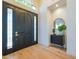 Inviting entryway with hardwood floors, mirror and decorative cabinet at 3153 E Sierra Vista Dr, Phoenix, AZ 85016
