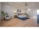 Open main bedroom with hardwood floors, ceiling fan, and ample natural light at 3153 E Sierra Vista Dr, Phoenix, AZ 85016