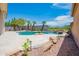 Swimming pool with rock features, lush landscaping and desert views in backyard oasis at 3153 E Sierra Vista Dr, Phoenix, AZ 85016