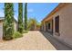 Backyard featuring gravel, desert landscaping, tall green trees, and covered patio at 35402 N 32Nd Dr, Phoenix, AZ 85086