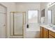 Bright bathroom with a separate glass shower, a soaking tub, and plenty of counter space at 35402 N 32Nd Dr, Phoenix, AZ 85086