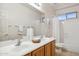Bathroom featuring double sinks, a large mirror, and a separate area for the bath and toilet at 35402 N 32Nd Dr, Phoenix, AZ 85086