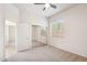 Bright bedroom with neutral carpet, ceiling fan, and mirrored closet doors at 35402 N 32Nd Dr, Phoenix, AZ 85086