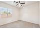 A bright bedroom with neutral carpet, ceiling fan and natural light at 35402 N 32Nd Dr, Phoenix, AZ 85086