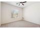 Bright bedroom with a ceiling fan, neutral walls, and carpet flooring at 35402 N 32Nd Dr, Phoenix, AZ 85086