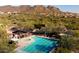 Aerial view of a community pool with lounge chairs and recreational area near the mountain landscape at 35402 N 32Nd Dr, Phoenix, AZ 85086