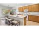 Bright kitchen features wooden cabinets and an island with bar seating at 35402 N 32Nd Dr, Phoenix, AZ 85086