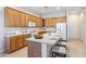 Spacious kitchen with wooden cabinets, an island with bar seating, and modern appliances at 35402 N 32Nd Dr, Phoenix, AZ 85086
