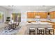 Bright kitchen features wooden cabinets, an island with bar seating, and an adjacent dining area at 35402 N 32Nd Dr, Phoenix, AZ 85086