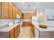 Spacious kitchen with wooden cabinets, ample counter space, and an island with a sink at 35402 N 32Nd Dr, Phoenix, AZ 85086