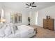Spacious main bedroom featuring a ceiling fan, natural light and a view to the outside at 35402 N 32Nd Dr, Phoenix, AZ 85086