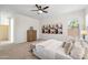 Inviting main bedroom with a ceiling fan, neutral carpet, and plenty of natural light at 35402 N 32Nd Dr, Phoenix, AZ 85086